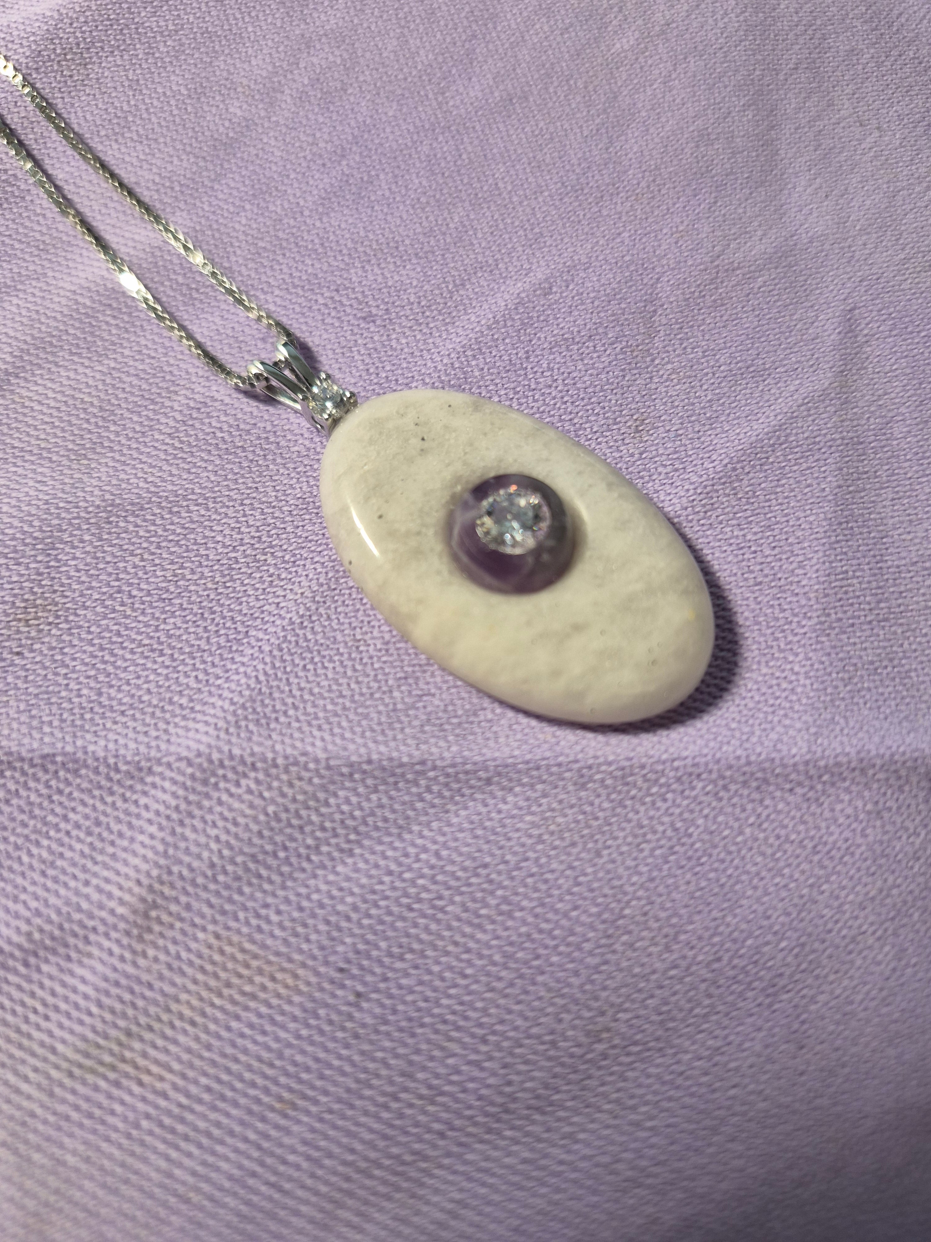 Oval stone pendant with CZ mounted on amethyst
