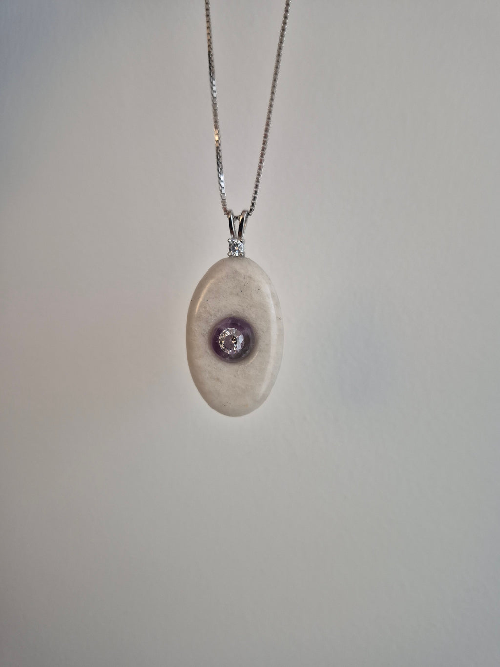 Oval stone pendant with CZ mounted on amethyst