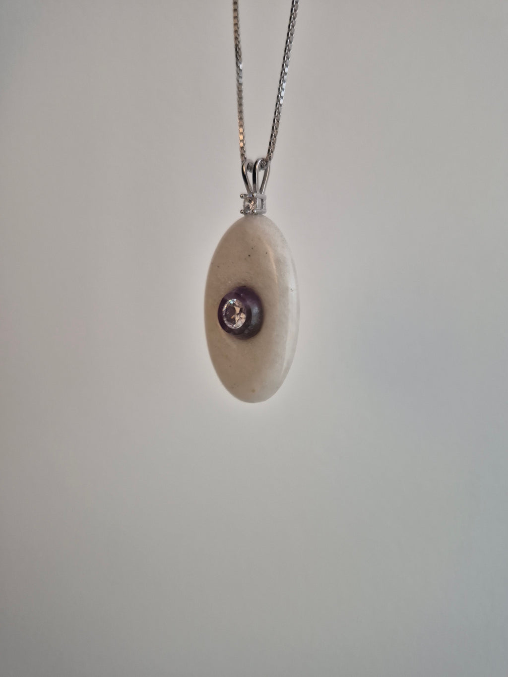 Oval stone pendant with CZ mounted on amethyst
