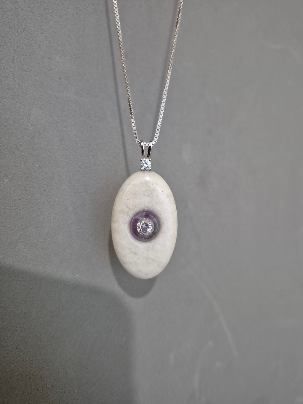 Oval stone pendant with CZ mounted on amethyst