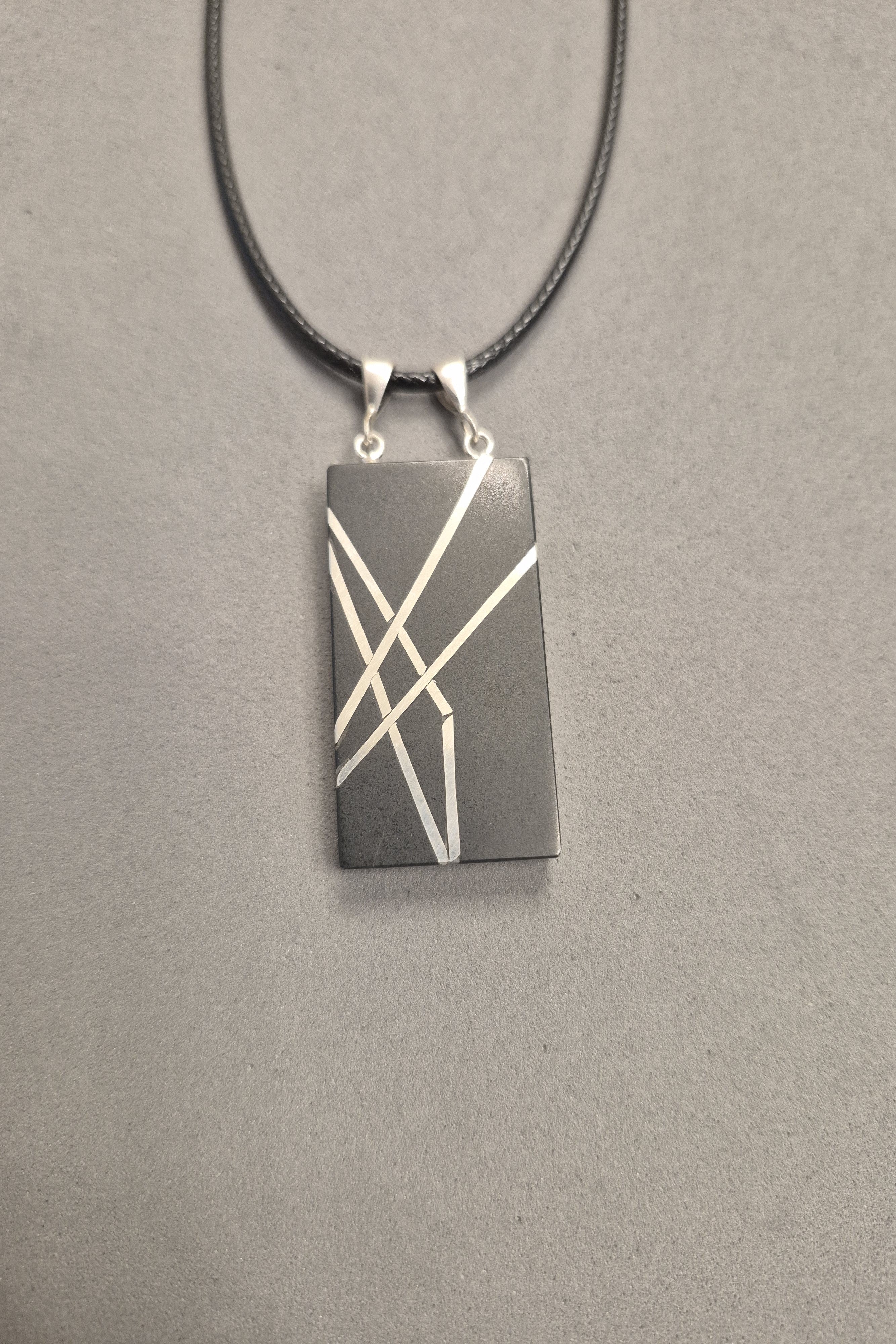 Geometric silver on black necklace