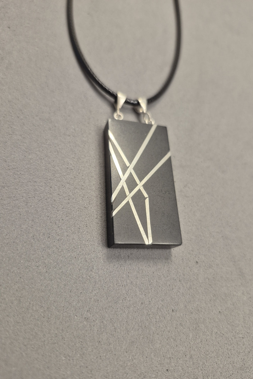 Geometric silver on black necklace