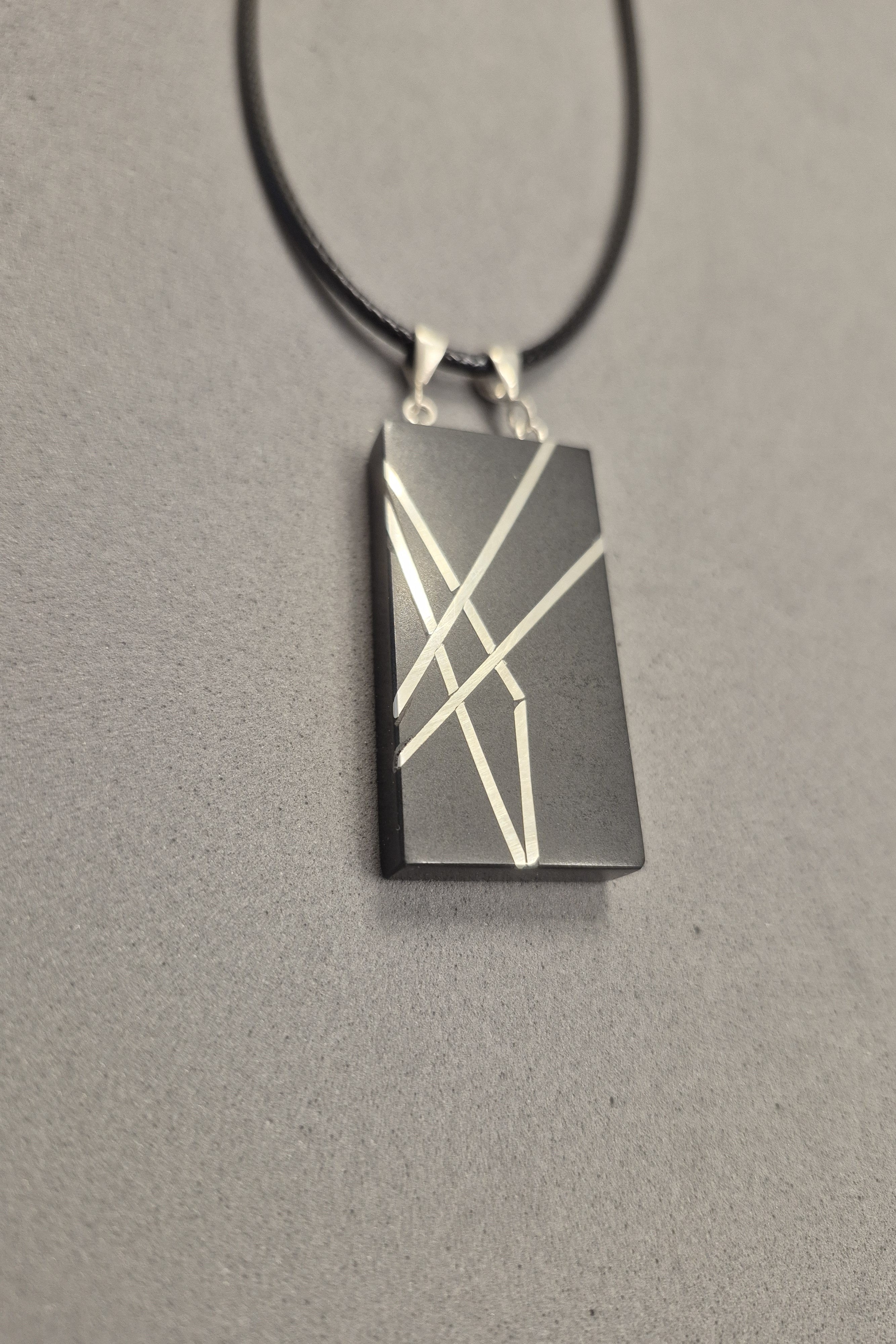 Geometric silver on black necklace