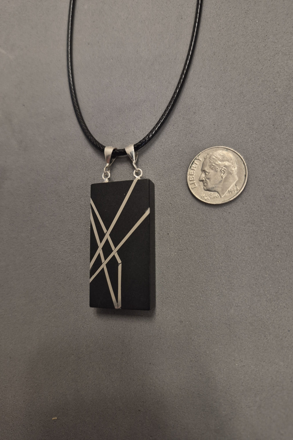 Geometric silver on black necklace