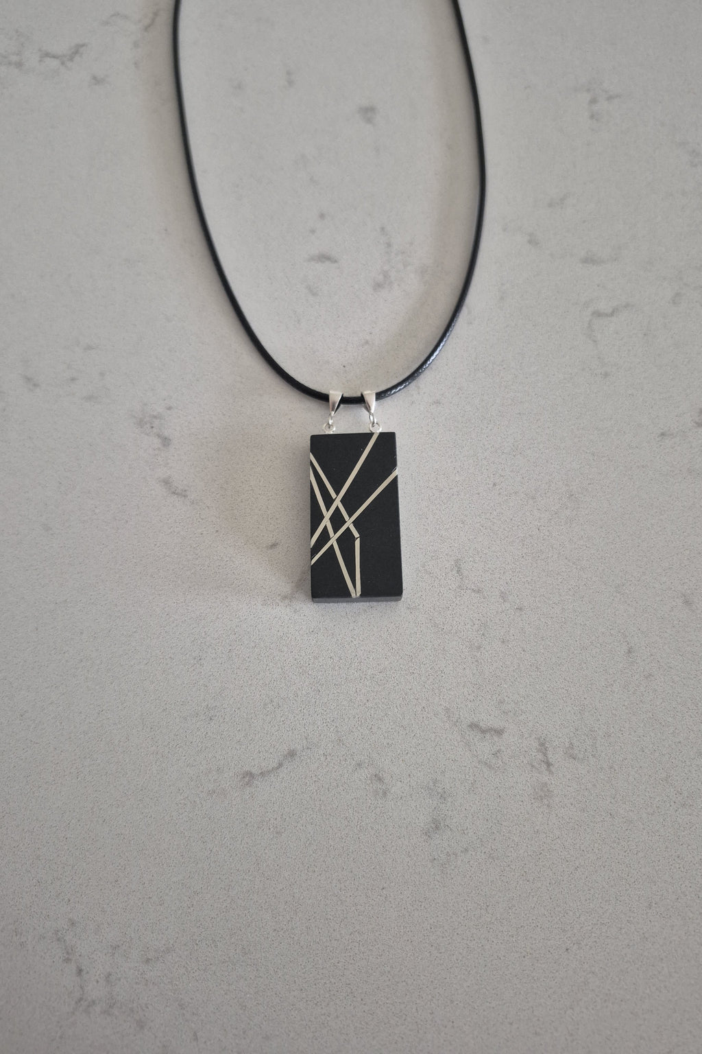 Geometric silver on black necklace