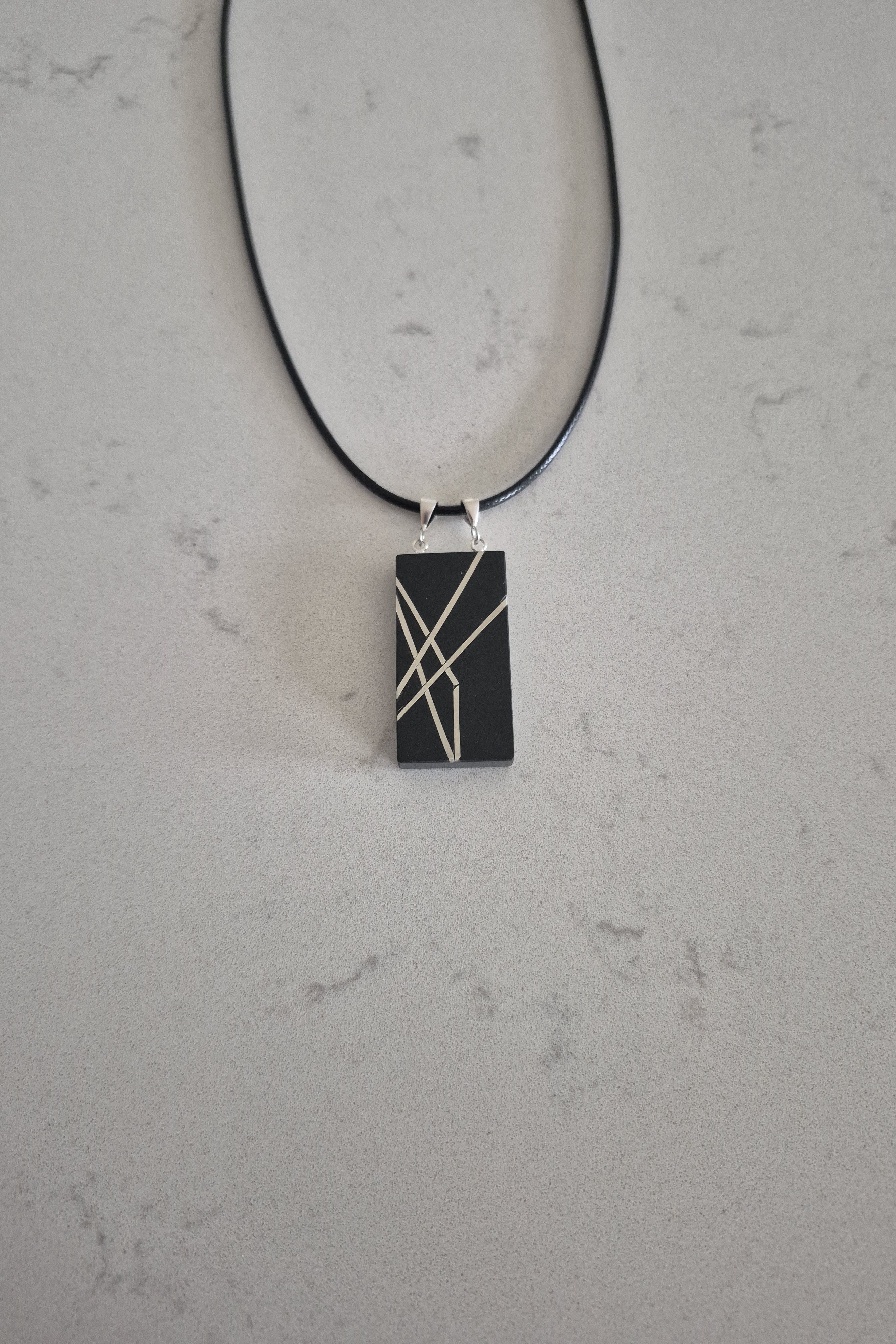 Geometric silver on black necklace