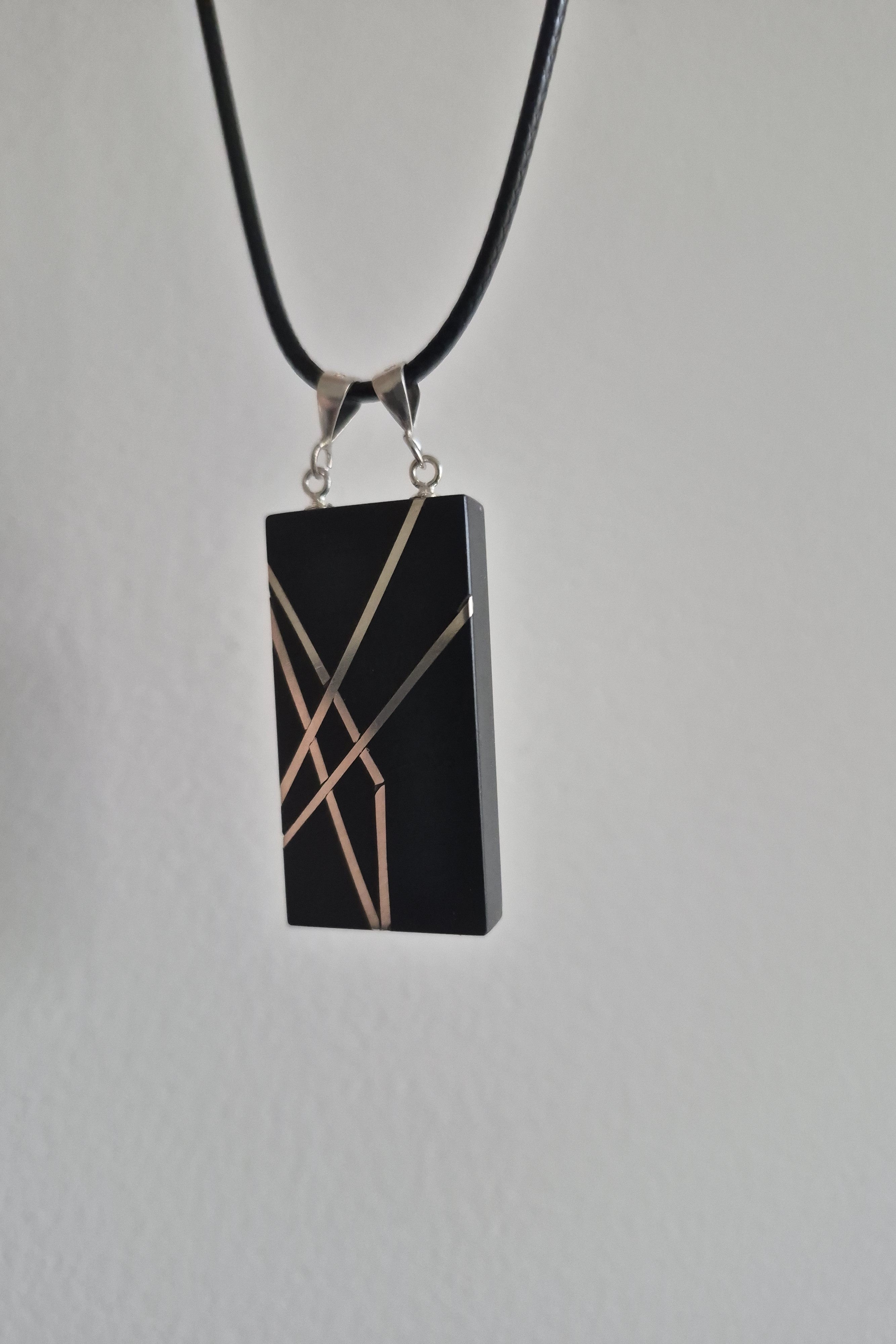 Geometric silver on black necklace