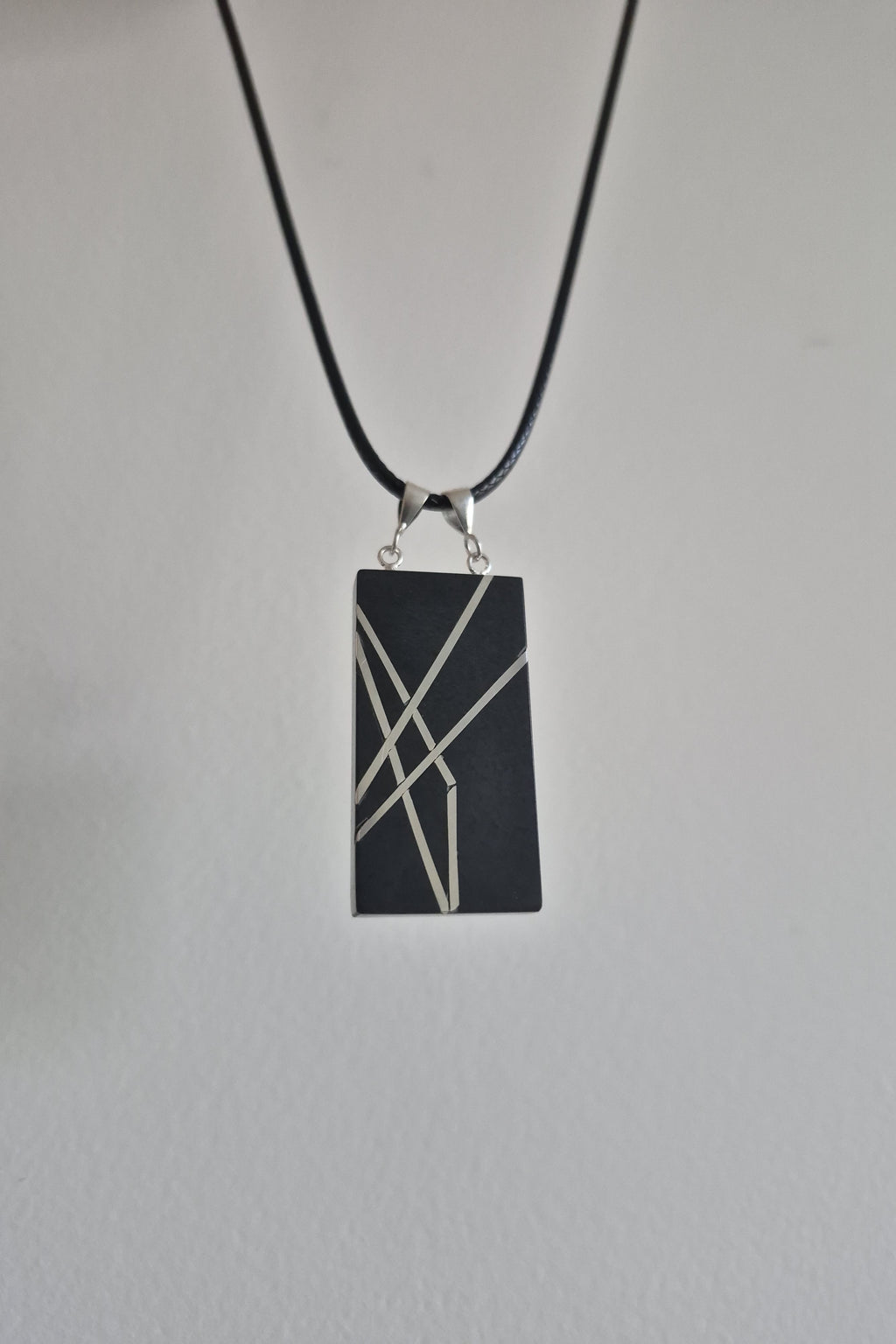 Geometric silver on black necklace