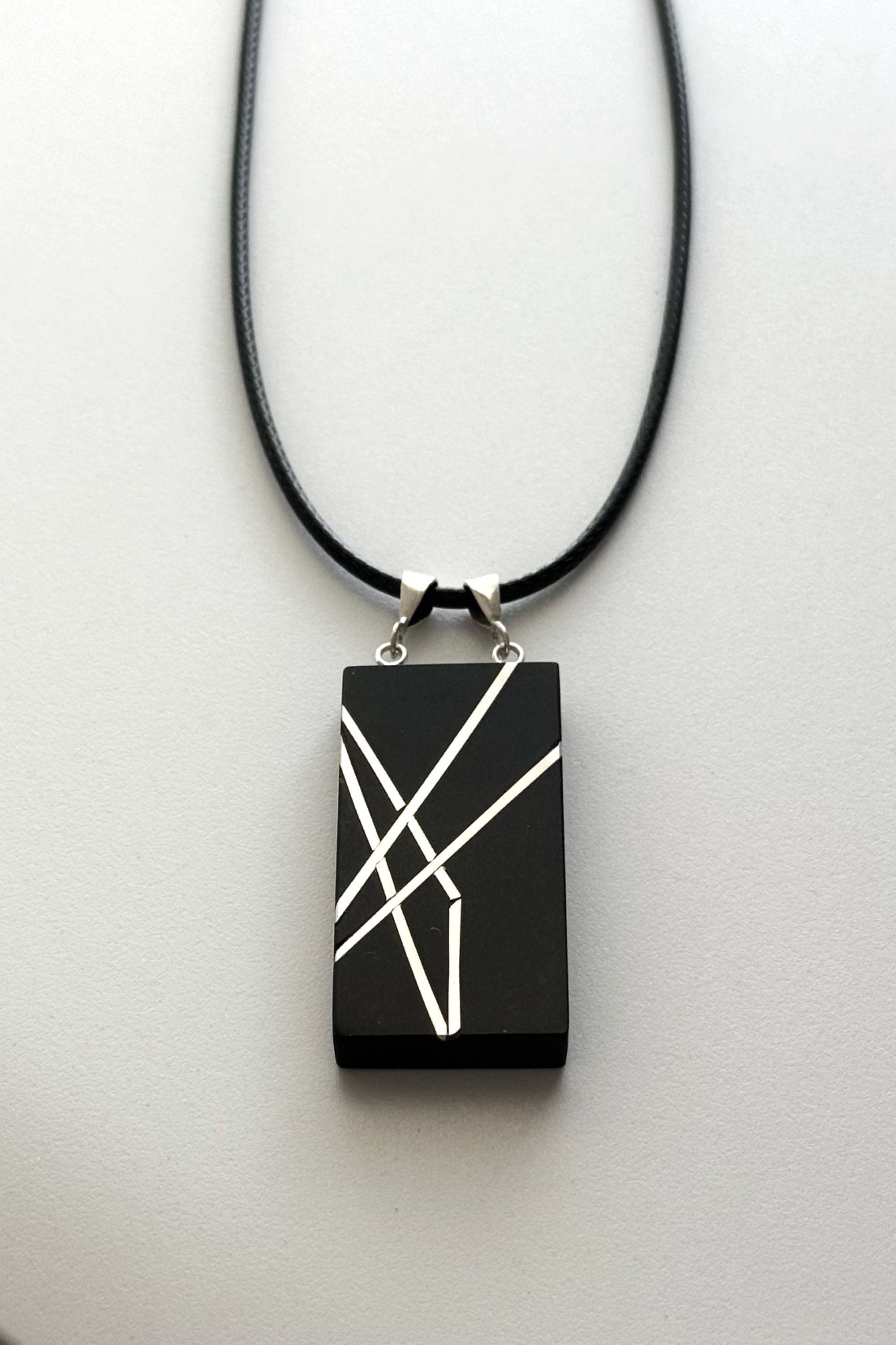 Geometric silver on black necklace