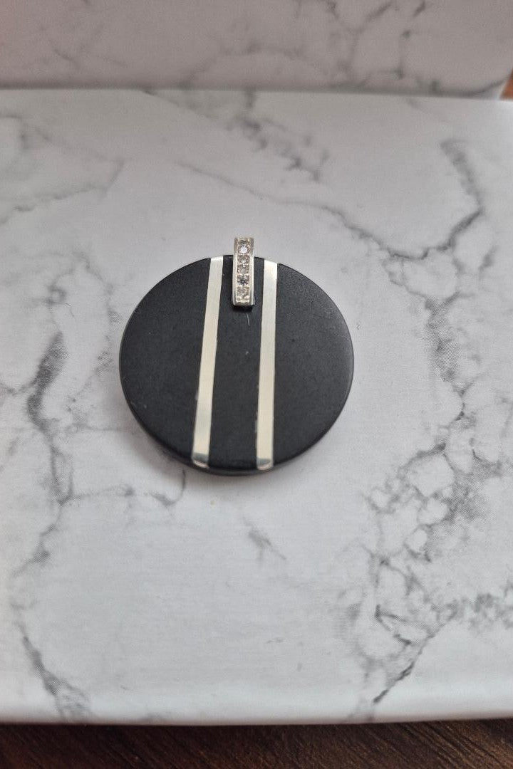Black and silver circular stone pendant