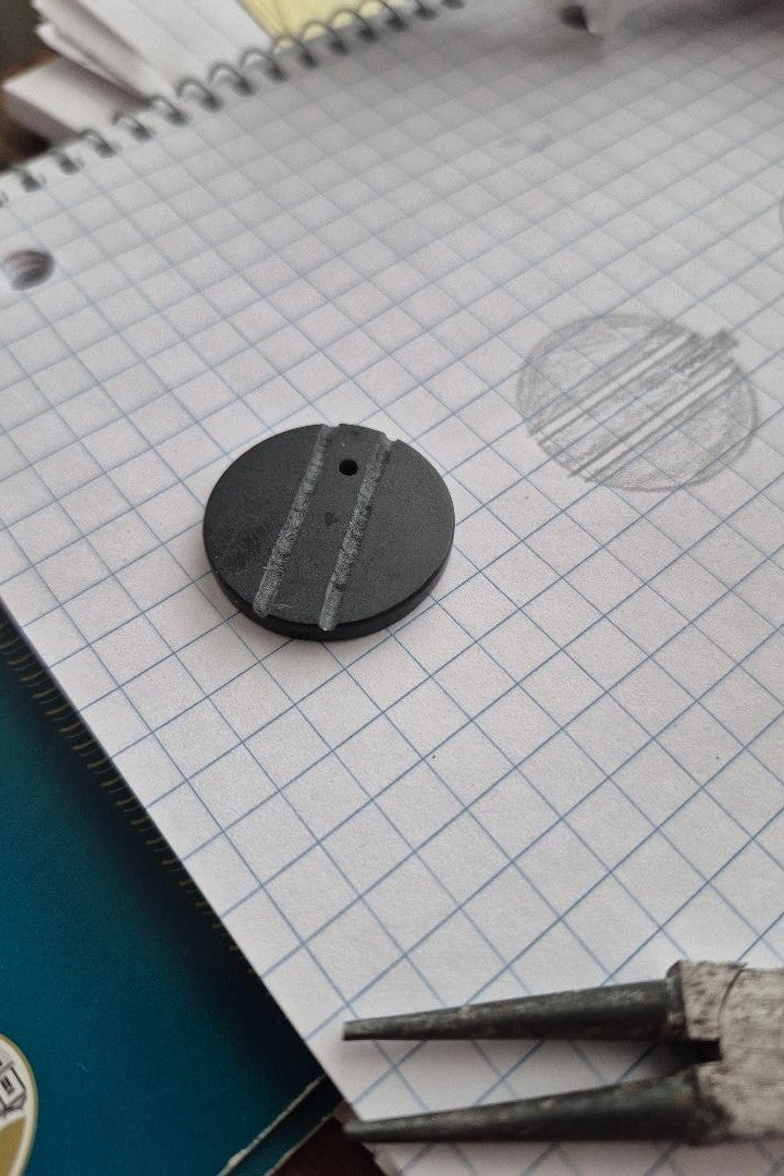Black and silver circular stone pendant